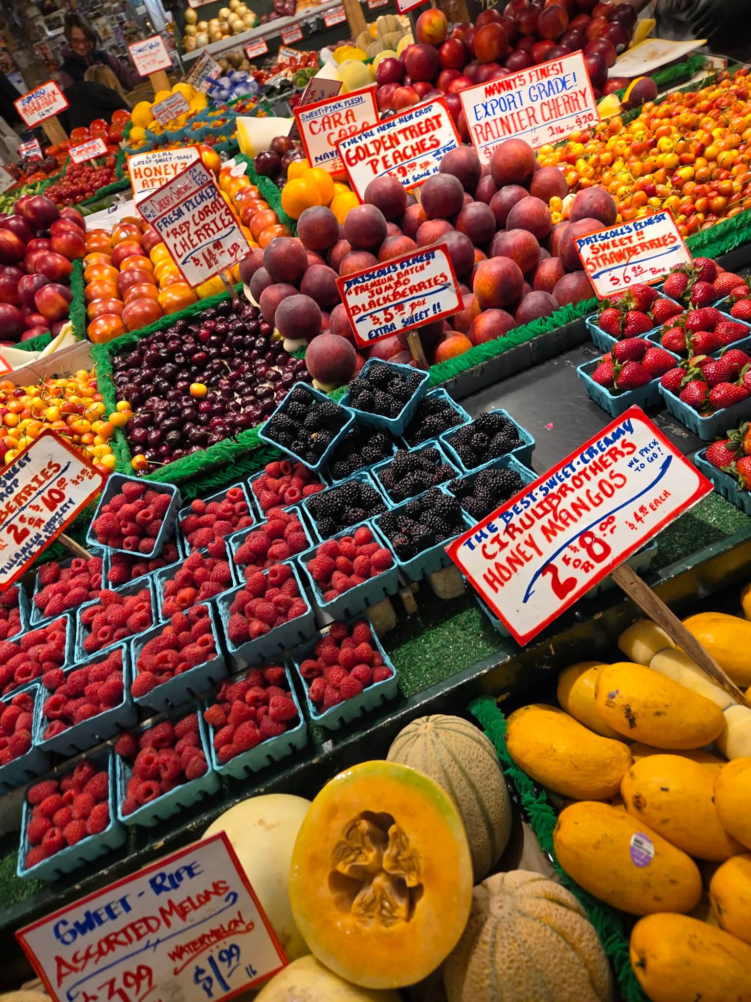 Pike Place Market Seattle with vibrant fresh flower stands and colorful produce displays on a rainy day in late May